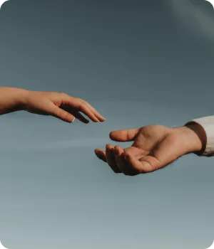 Two hands reaching toward each other in support