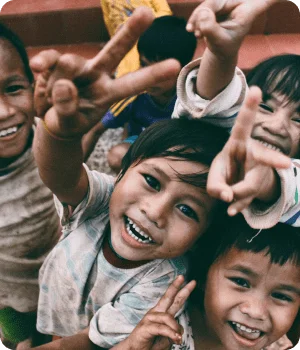 Smiling children supported by Mona Foundation programs