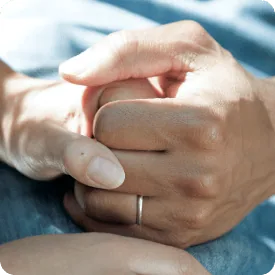 Hands held in support, integrative cancer supportive care at Holistique Medical Center, Bellevue